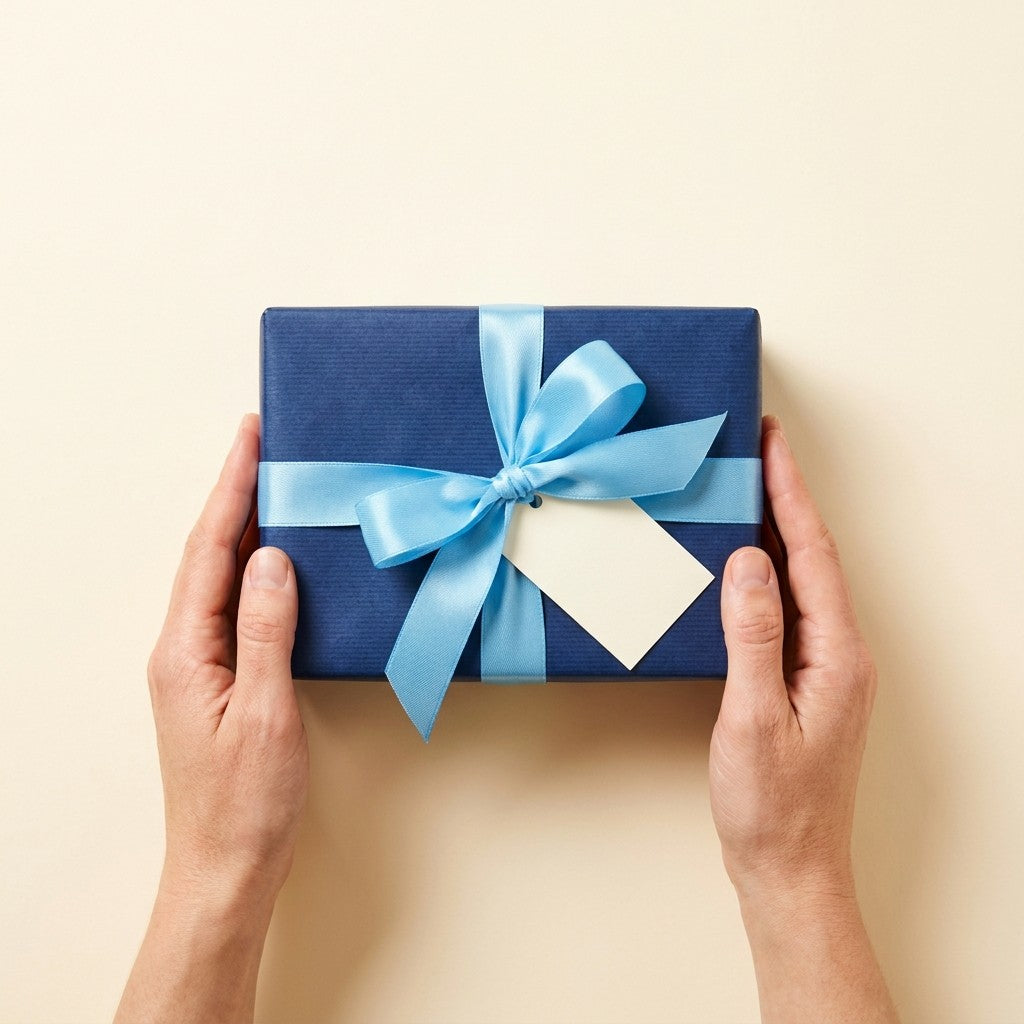 Gift wrapped in navy paper with a sky-blue bow